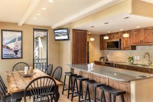an open kitchen with a large island with black bar stools at Luxury 2 Bedroom Lionshead Village Condo, Short Walk To Gondola in Vail