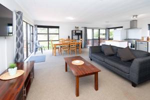 a living room with a couch and a table at Bucks Point - Norfolk Island Holiday Homes in Burnt Pine