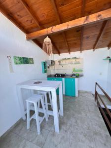 een keuken met een witte tafel en stoelen bij Complejo Noi Alaia in Valeria del Mar +5 foto's
