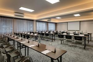 a conference room with tables and chairs and a whiteboard at Protea Hotel by Marriott Cape Town Sea Point in Cape Town +81 photos