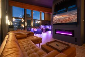 a living room with a large couch and a fireplace at Modern Mtn-View Retreat, 18 Mi to Zion North in Cedar City