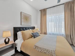 a bedroom with a large bed and a window at Sophisticated Dallas Retreat l Prime Location! in Dallas