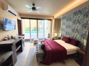 a bedroom with a bed and a desk and a sink at Beautiful studio in Puerto Vallarta