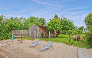 a yard with two chairs and a table and a shed at Ferienwohnung Waren Müritz in Waren +13 photos
