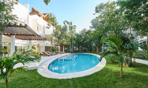una piscina en el patio de una casa en Aldea Zama Condo with 2 Pools, Gym, Yoga Deck and BBQ Grill, en Tulum