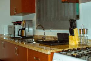 a kitchen counter with a sink and a stove at Bubali V in Palm-Eagle Beach
