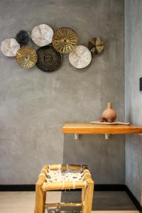 a shelf with plates on a wall with a chair at Luxury Studio with Rooftop Pool and Gym in Top Location in Tulum +32 photos