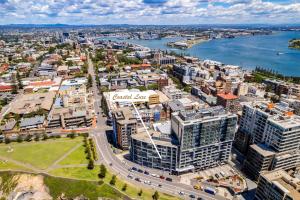 an aerial view of a city with a body of water at Coastal Luxe - Eats, Walks, Swims - 1 Car in Newcastle