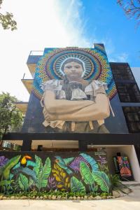 a mural of a woman on the side of a building at Luxury Studio with Rooftop Pool and Gym in Top Location in Tulum