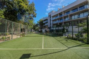 a tennis court in front of a building at Luxury Studio with Rooftop Pool and Gym in Top Location in Tulum
