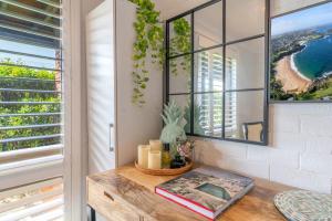 a room with a table with candles and a view of the ocean at Kiama Mountain Views Studio in Kiama