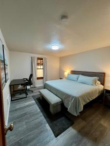 a bedroom with a bed and a desk and a piano at Forks Cedar House in Forks
