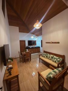 a living room with a couch and a table at Village da Mata Arraial in Porto Seguro