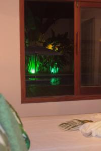 a view of a window with green lights at Village da Mata Arraial in Porto Seguro