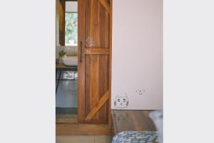 a door to a bathroom with a cat sticker on it at Sleepy House Chiang Rai in Chiang Rai