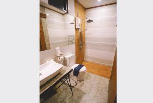 a bathroom with a sink and a toilet at Sleepy House Chiang Rai in Chiang Rai