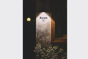 a sign that reads room is lit up in a window at Sleepy House Chiang Rai in Chiang Rai