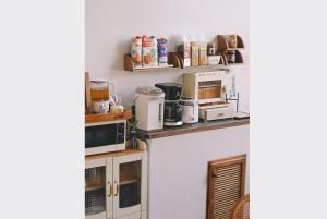 a kitchen with several appliances on a counter at Sleepy House Chiang Rai in Chiang Rai