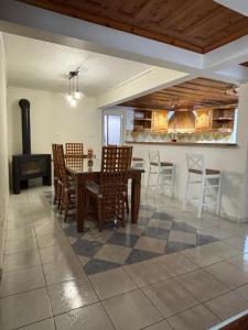 a dining room with a table and chairs and a stove at La Kaz ô Cap in Cilaos