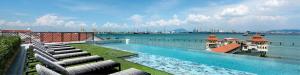 a large swimming pool with a view of the water at The Prestige Hotel Penang, a Member of Design Hotels in George Town