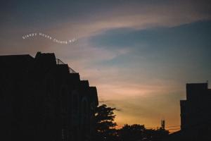 a silhouette of a city skyline with a sunset at Sleepy House Chiang Rai in Chiang Rai