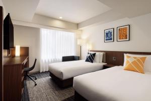 Postel nebo postele na pokoji v ubytování Four Points Flex by Sheraton Kyoto Oike