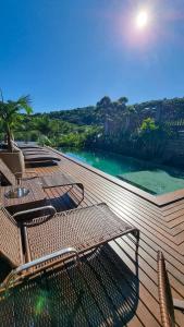 a deck with chairs and a view of the water at Pousada Valle Paradiso in Praia do Rosa