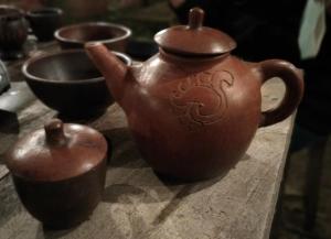 a group of vases sitting on a wooden table at Puri kahuripan in Kediri +7 photos