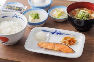 a plate with a fish and rice and bowls of food at Four Points Flex by Sheraton Kyoto Oike in Kyoto