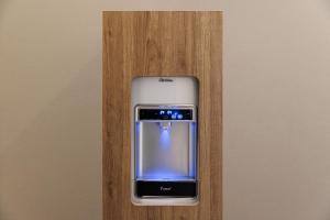 a cell phone is sitting on a wooden shelf at Four Points Flex by Sheraton Kyoto Oike in Kyoto