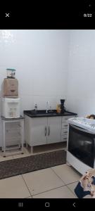 a kitchen with a sink and a counter top at Casa Aconchegante Votuporanga in Votuporanga