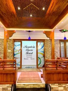 a church with a large window with a sign on it at Mountain Breeze Resort Vattavada in Munnar