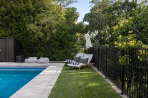 a backyard with a swimming pool and a fence at Kopanga House - Havelock North Village in Havelock North +21 photos