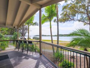 a balcony with chairs and a view of the water at NRMA Blue Dolphin Yamba Holiday Resort in Yamba +35 photos