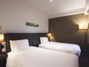 Postel nebo postele na pokoji v ubytování Hotel Gracery Tokyo Tamachi