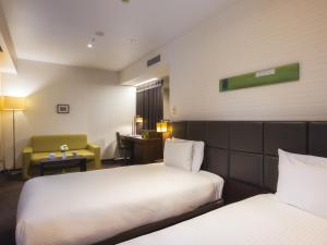 Postel nebo postele na pokoji v ubytování Hotel Gracery Tokyo Tamachi