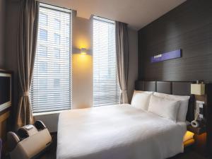 Postel nebo postele na pokoji v ubytování Hotel Gracery Tokyo Tamachi