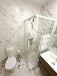 a bathroom with a shower and a toilet and a sink at Espinho in São Félix da Marinha +11 photos