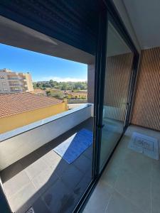a balcony with a view of a building at Espinho in São Félix da Marinha