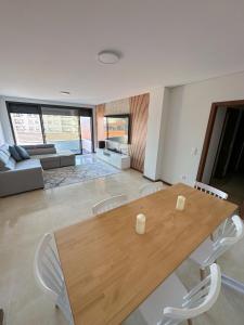 a living room with a wooden table and chairs at Espinho in São Félix da Marinha