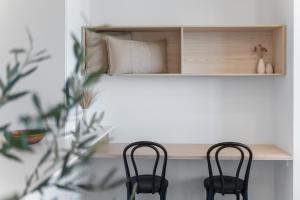 two chairs sitting next to a bed in a room at Coastal Luxe - Eats, Walks, Swims - 1 Car in Newcastle +13 photos