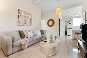 a living room with a couch and a table at Pad Off Pier - 2BR, Wifi in Glenelg