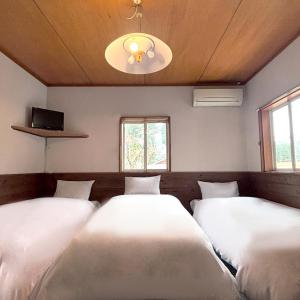 Postel nebo postele na pokoji v ubytování Guest House Vingt-Neuf 美好境界湯澤館