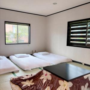 Postel nebo postele na pokoji v ubytování Guest House Vingt-Neuf 美好境界湯澤館