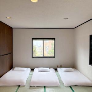 Postel nebo postele na pokoji v ubytování Guest House Vingt-Neuf 美好境界湯澤館