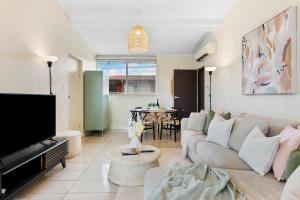 a living room with a couch and a table at Pad Off Pier - 2BR, Wifi in Glenelg