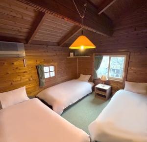 Postel nebo postele na pokoji v ubytování Guest House Vingt-Neuf 美好境界湯澤館