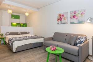 a living room with a bed and a couch at Mary's Luxury in Chrysi Ammoudia +46 photos