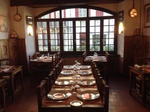 a dining room with a long table with plates on it at Auberge des Seigneurs in Vence +15 photos
