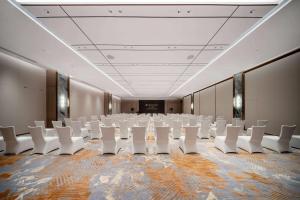 a large room with white chairs in it at Wyndham Grand Plaza Royale Lugu Changsha in Changsha